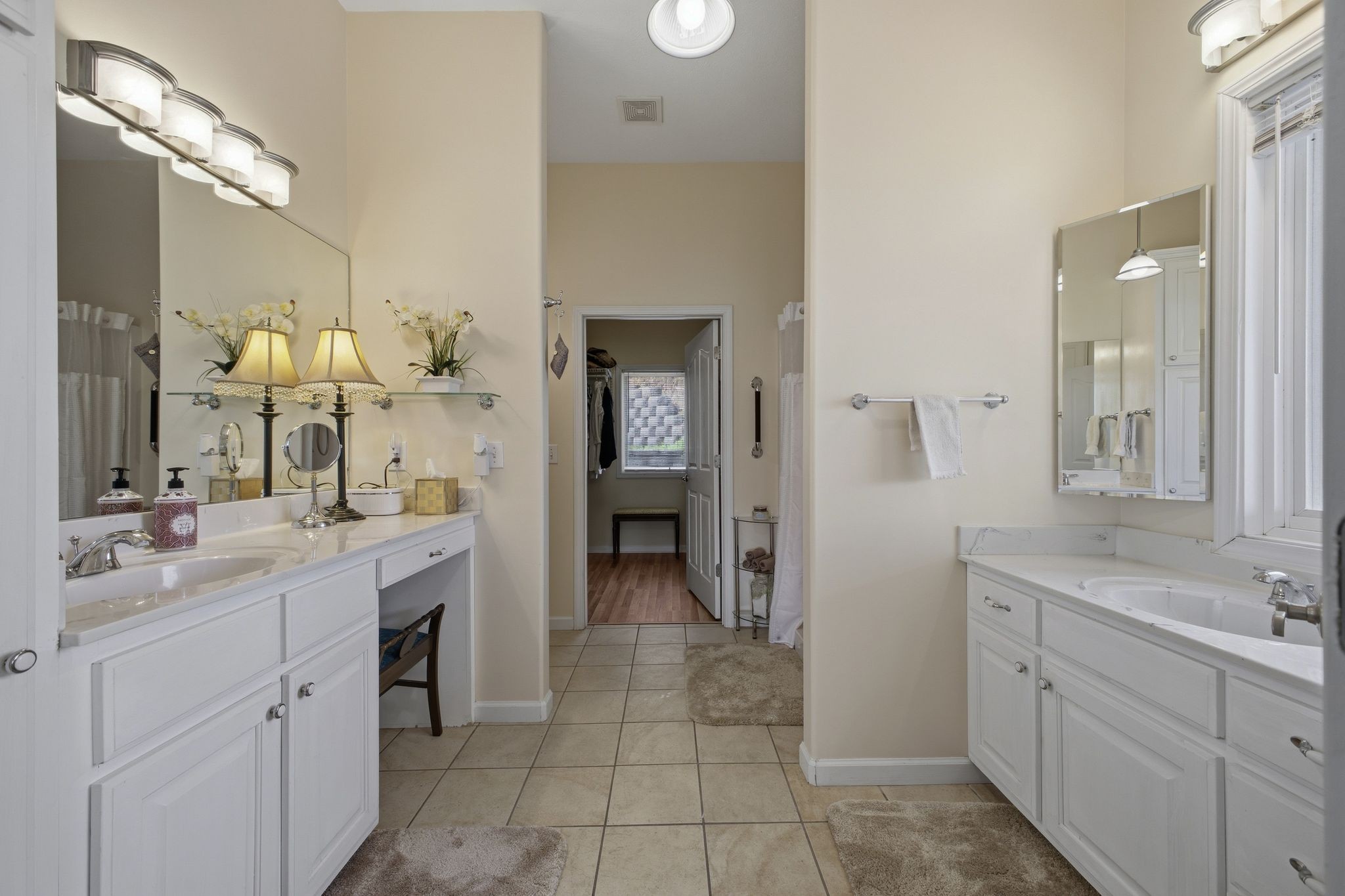 Primary bath with double vanities and walk-in closet